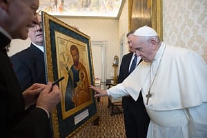 Pope Francis touches artwork of St. Joseph and the child Jesus as he meets Patrick E. Kelly, supreme knight of the Knights of Columbus, during an audience at the Vatican Oct. 25, 2021. The image is on display in the Catholic Churches in Santa Fe from April 30th – June 11th 2023.